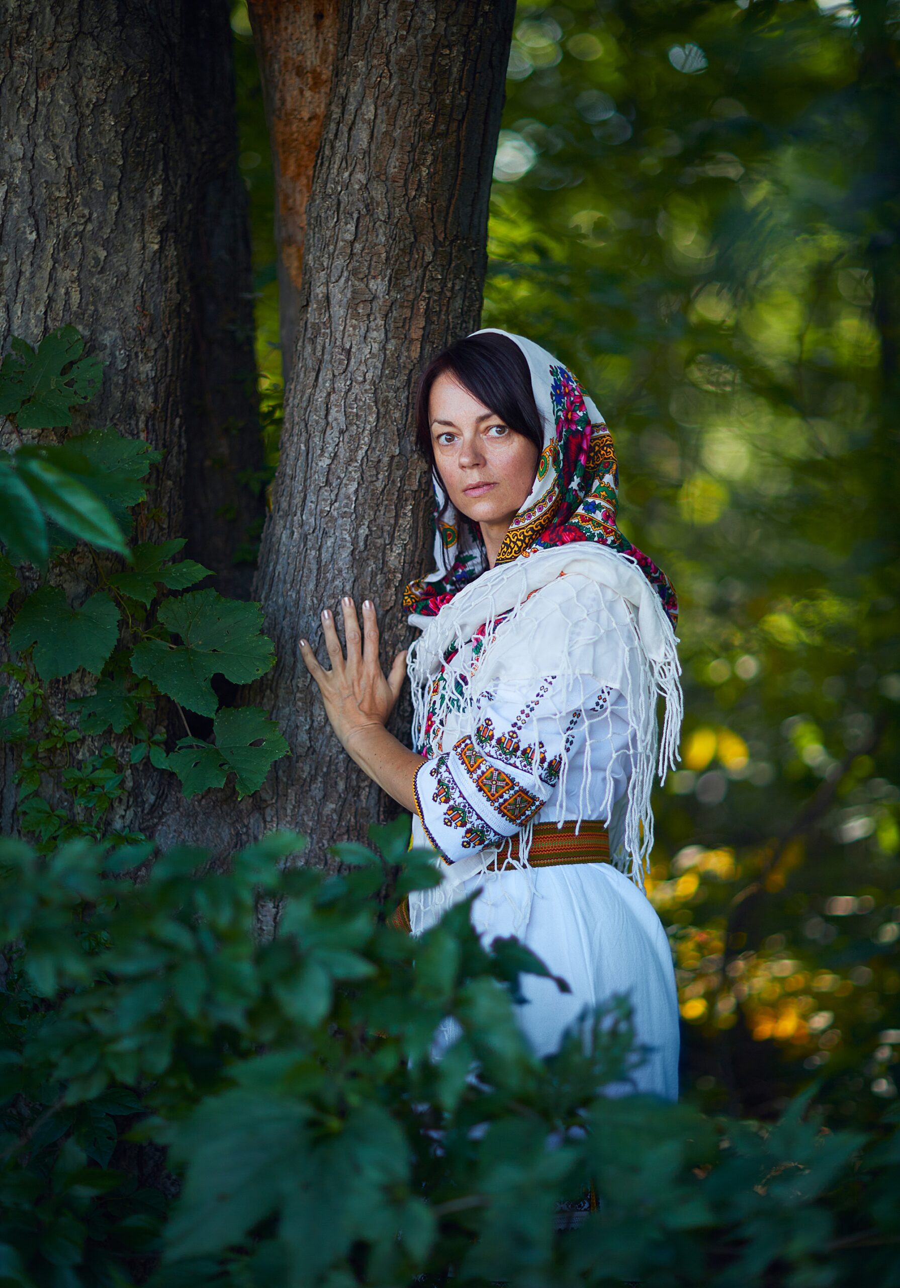 Slovak woman standing next to tree