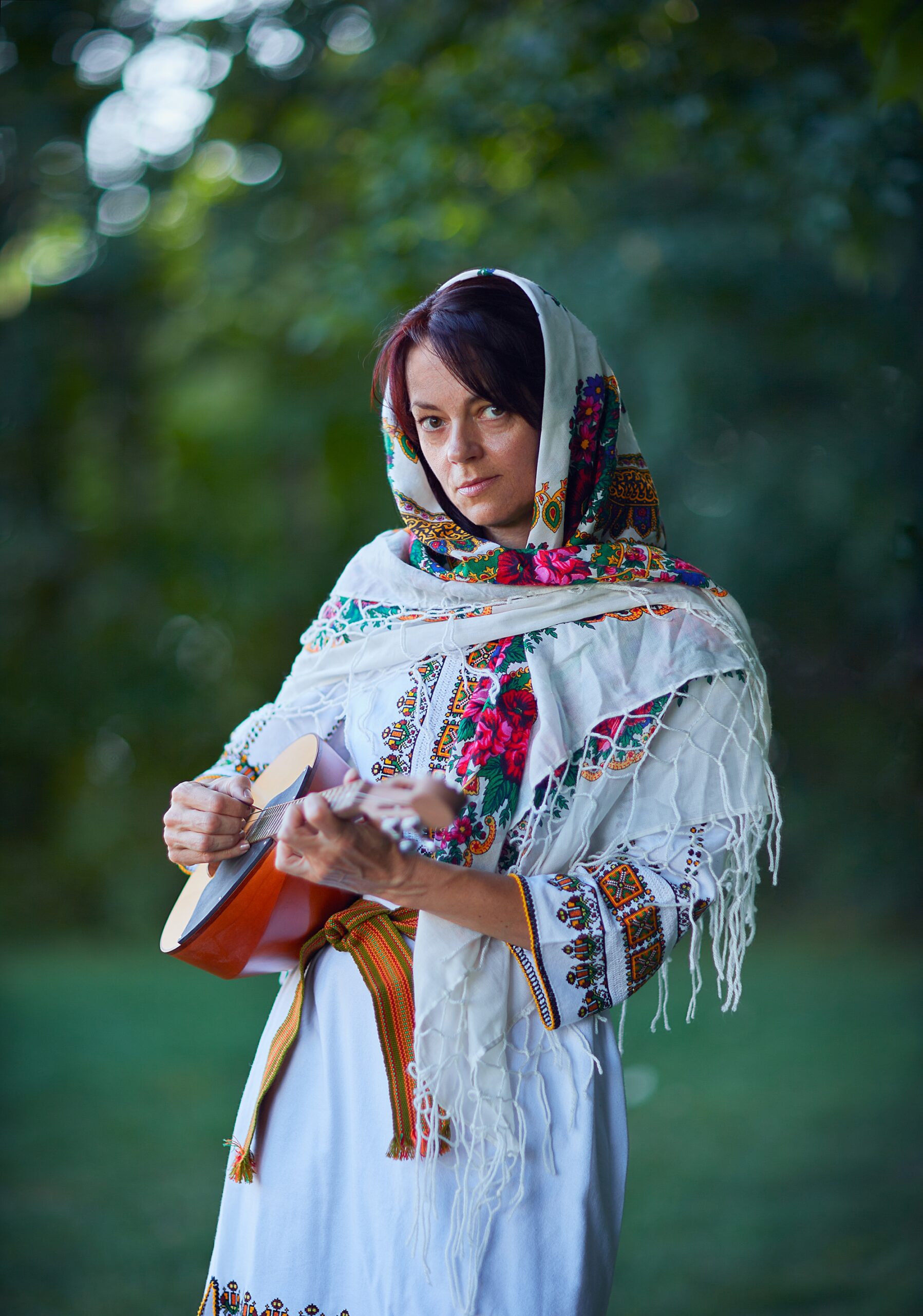 European woman holding guitar 