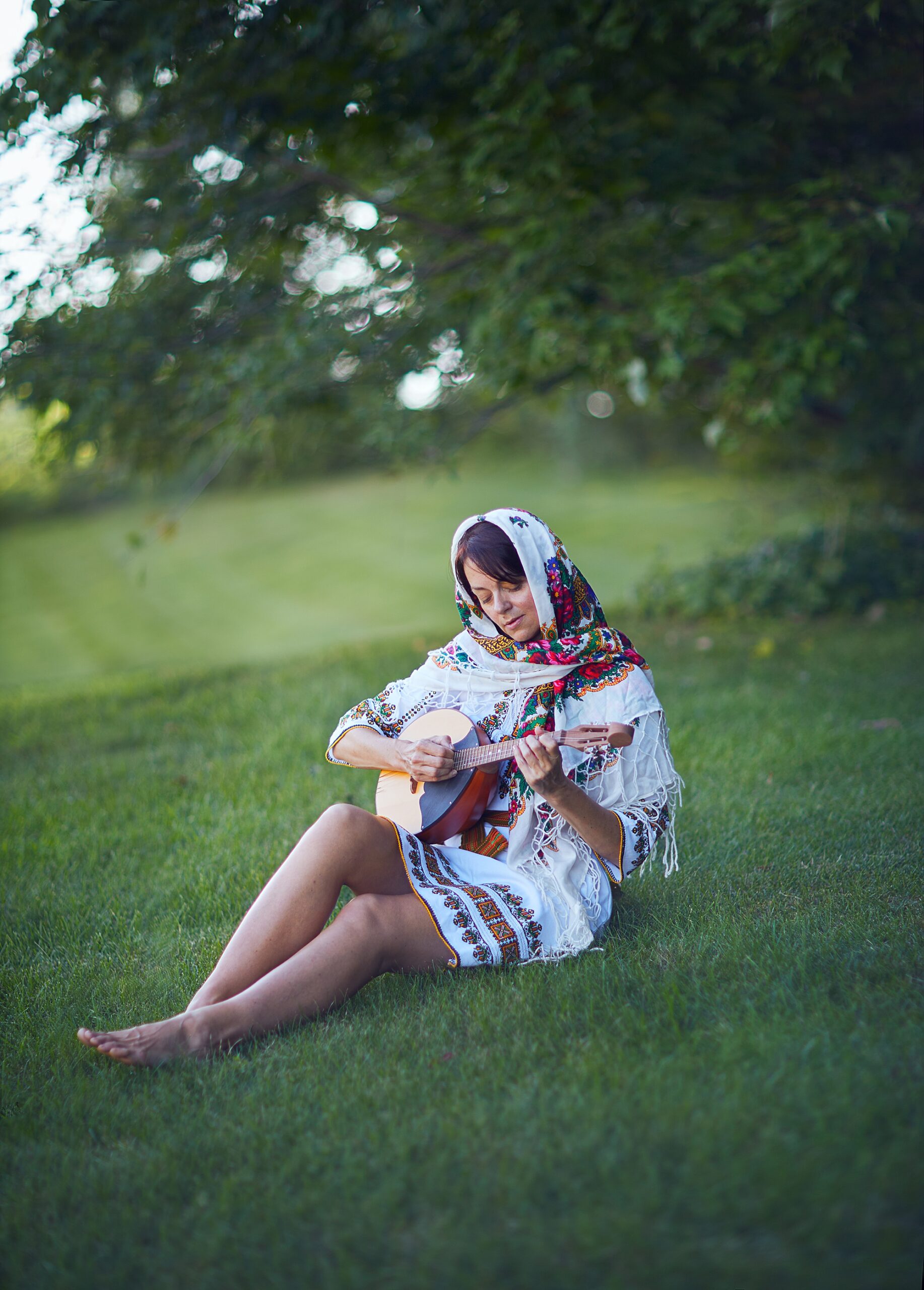 Slovak woman playing guitar in nature 