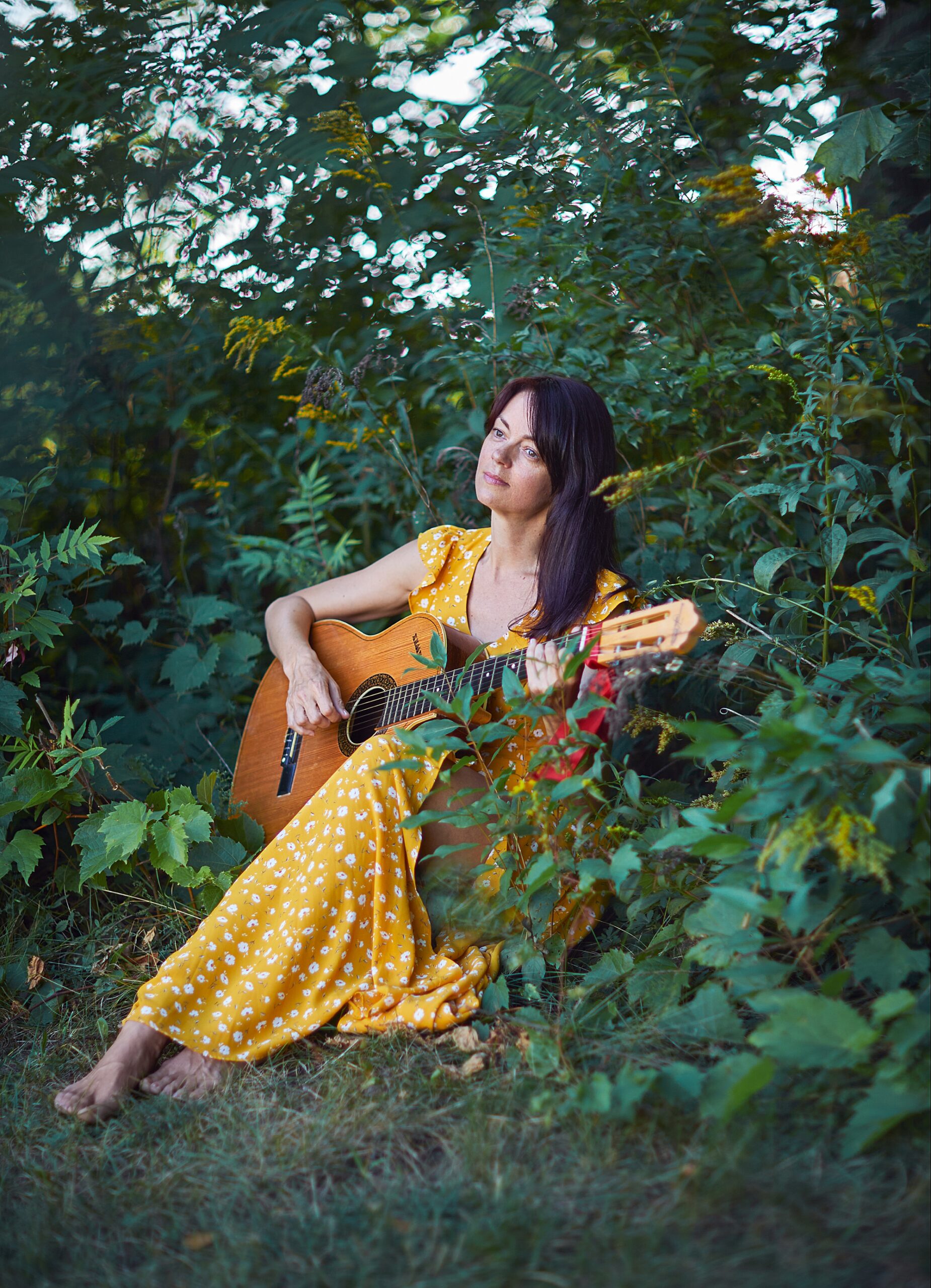 woman playing guitar in nature