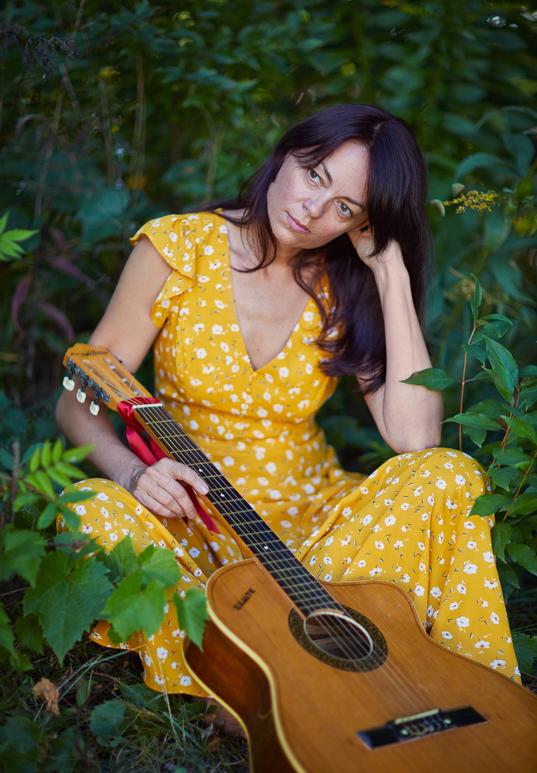 woman holding guitar in nature