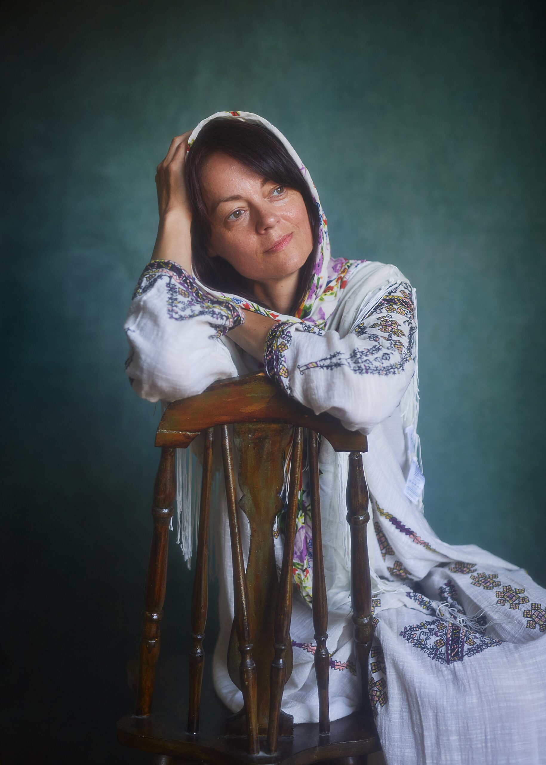 European woman sitting on wooden chair