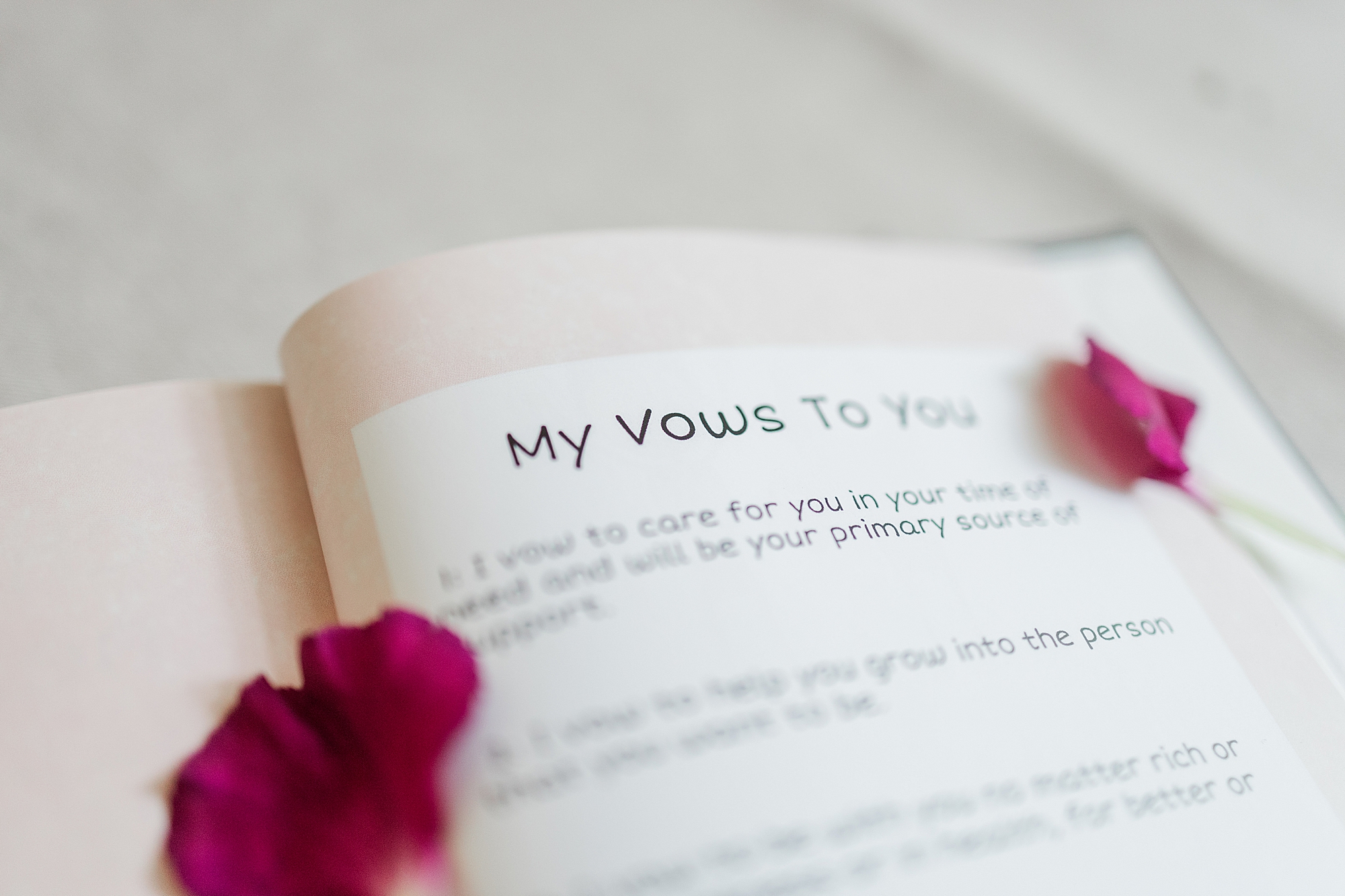 open vow book with flower petals on page 