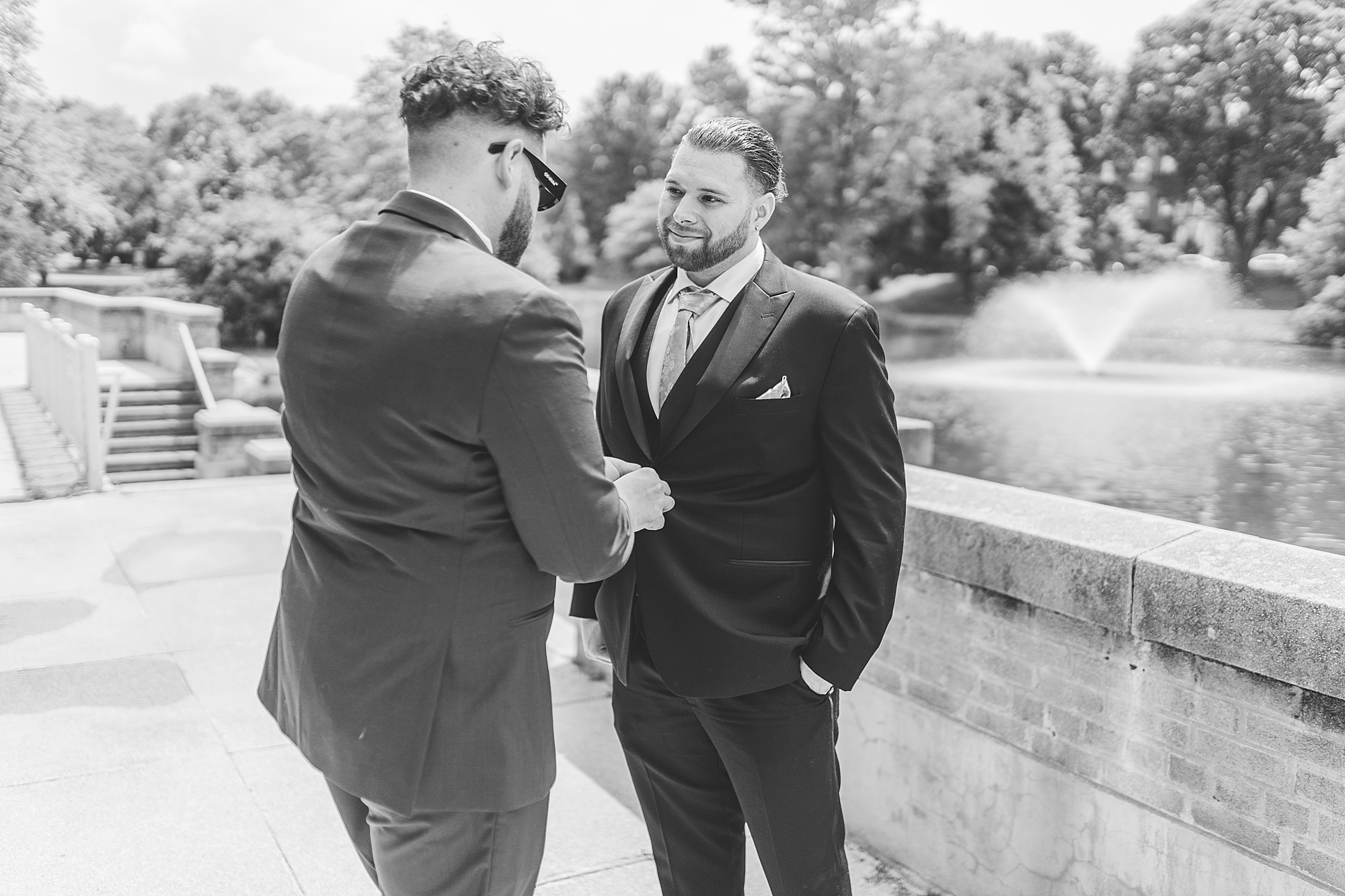 the best man helping groom get ready 