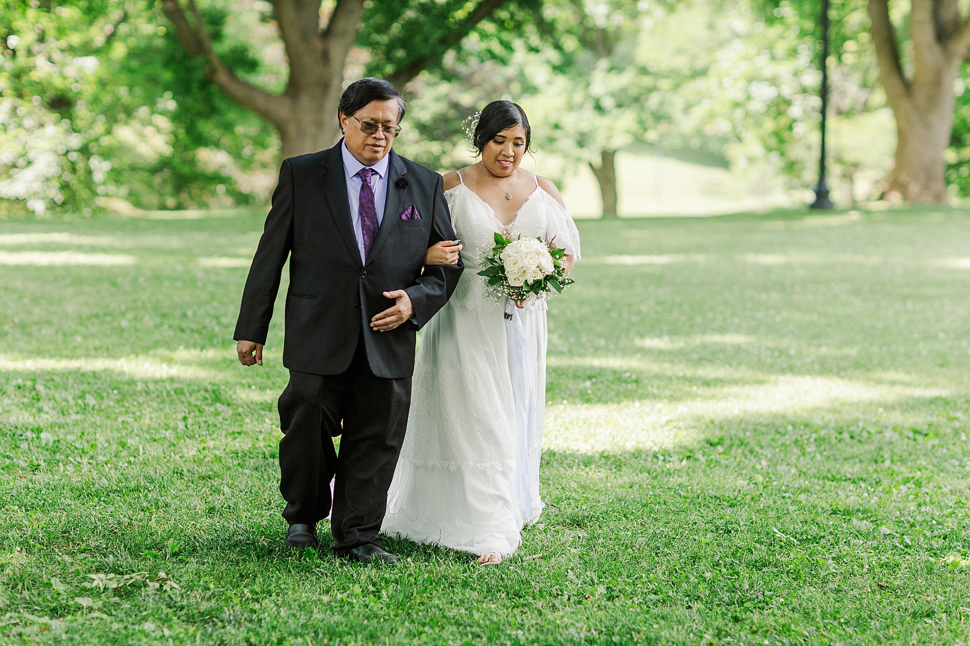 bride walking down aisle with father of bride 