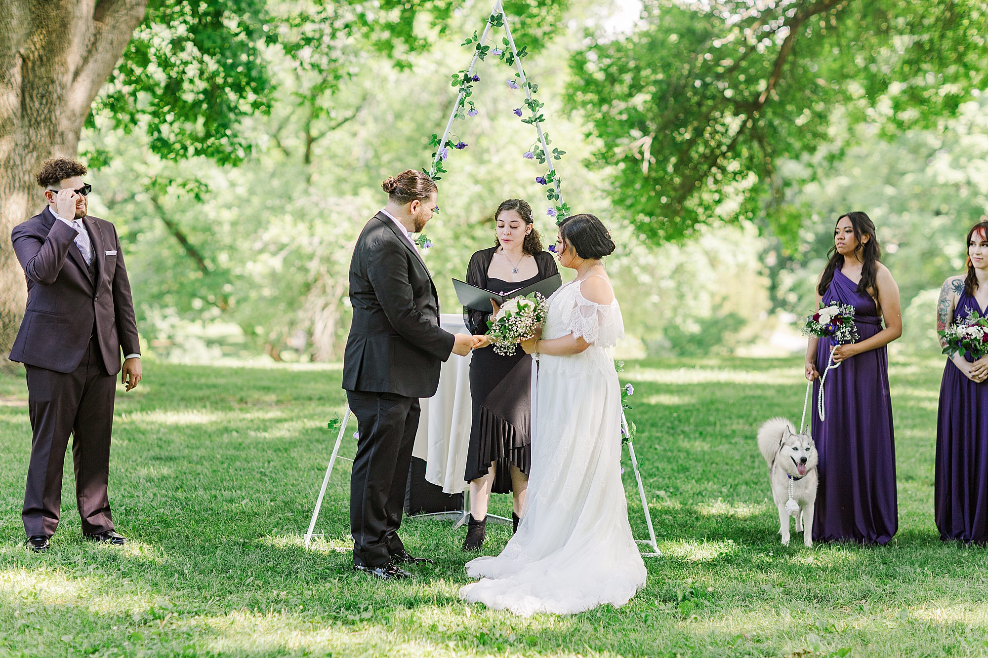 bride and groom with officiant during wedding ceremony 