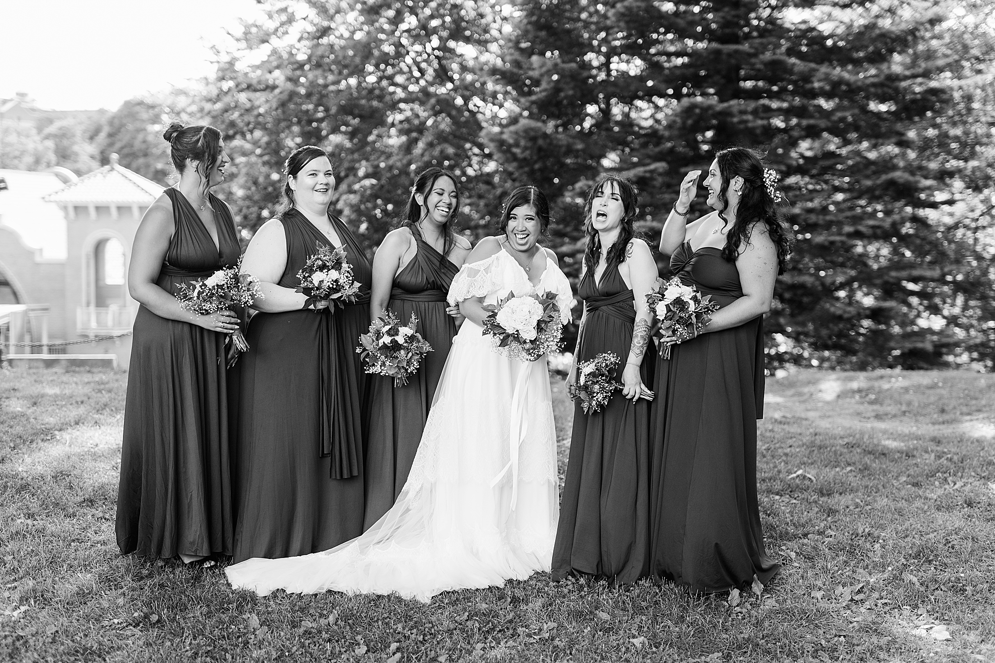 bridesmaids laughing with each other In park 