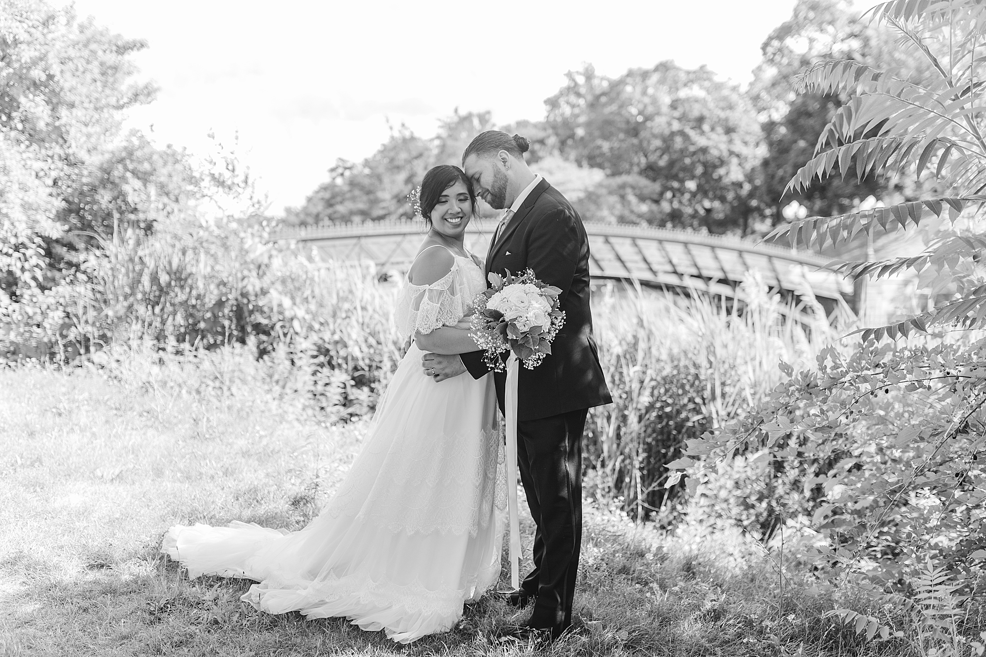 married couple holding each other in a park 