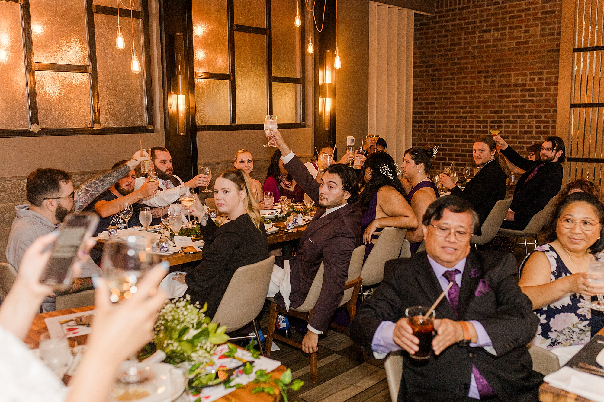 guests making a toast to bride and groom at wedding reception 