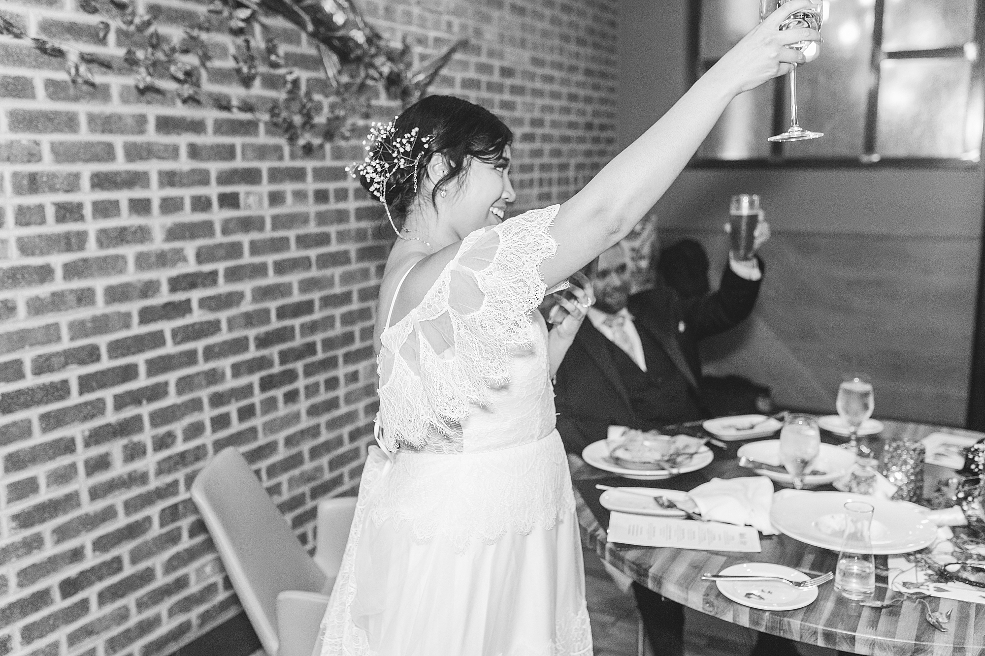 bride and groom making a toast at reception 