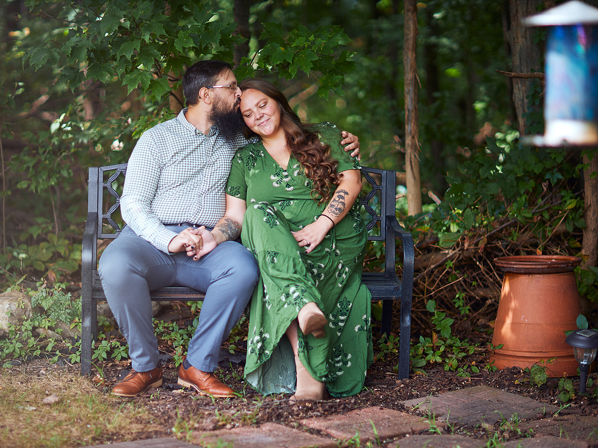 couple kissing on a bench