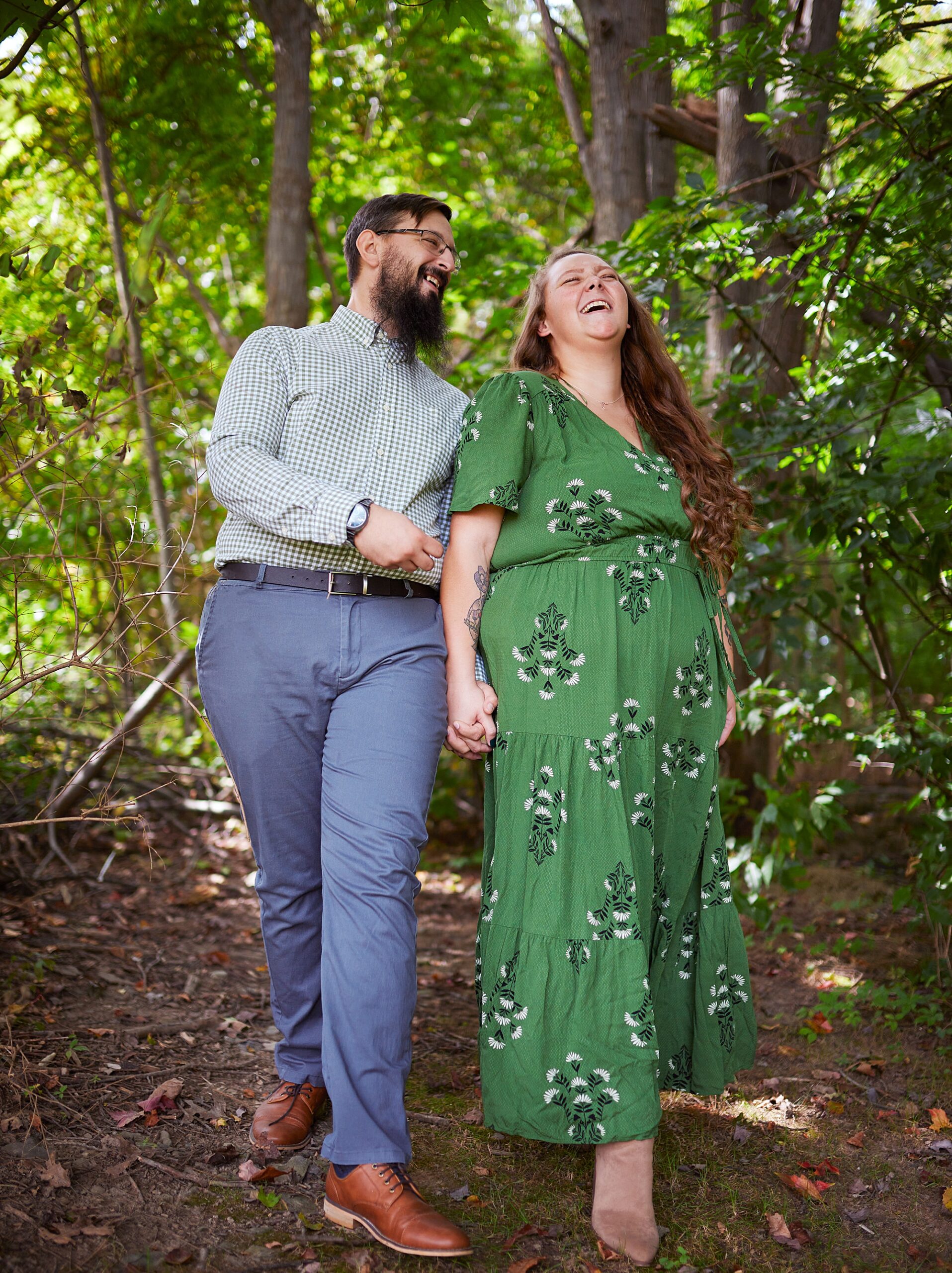 couple holding hands while walking and laughing