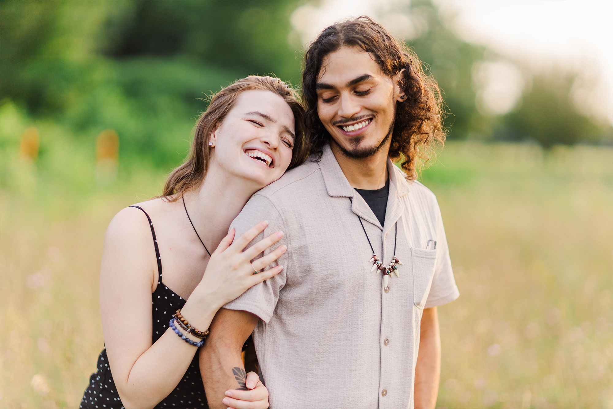 girlfriend and boyfriend in field laughing