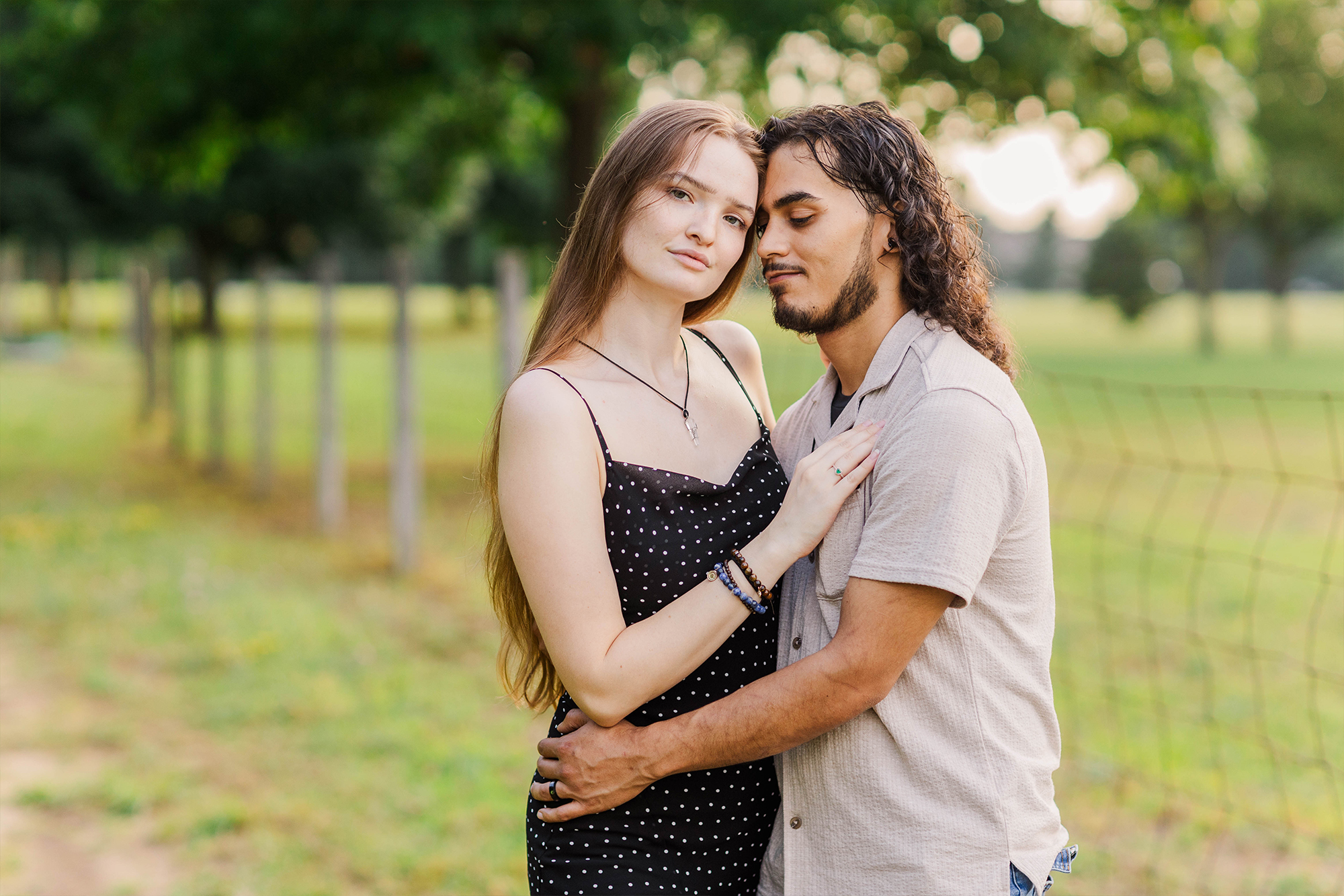 boyfriend and girlfriend embrace each other in park 