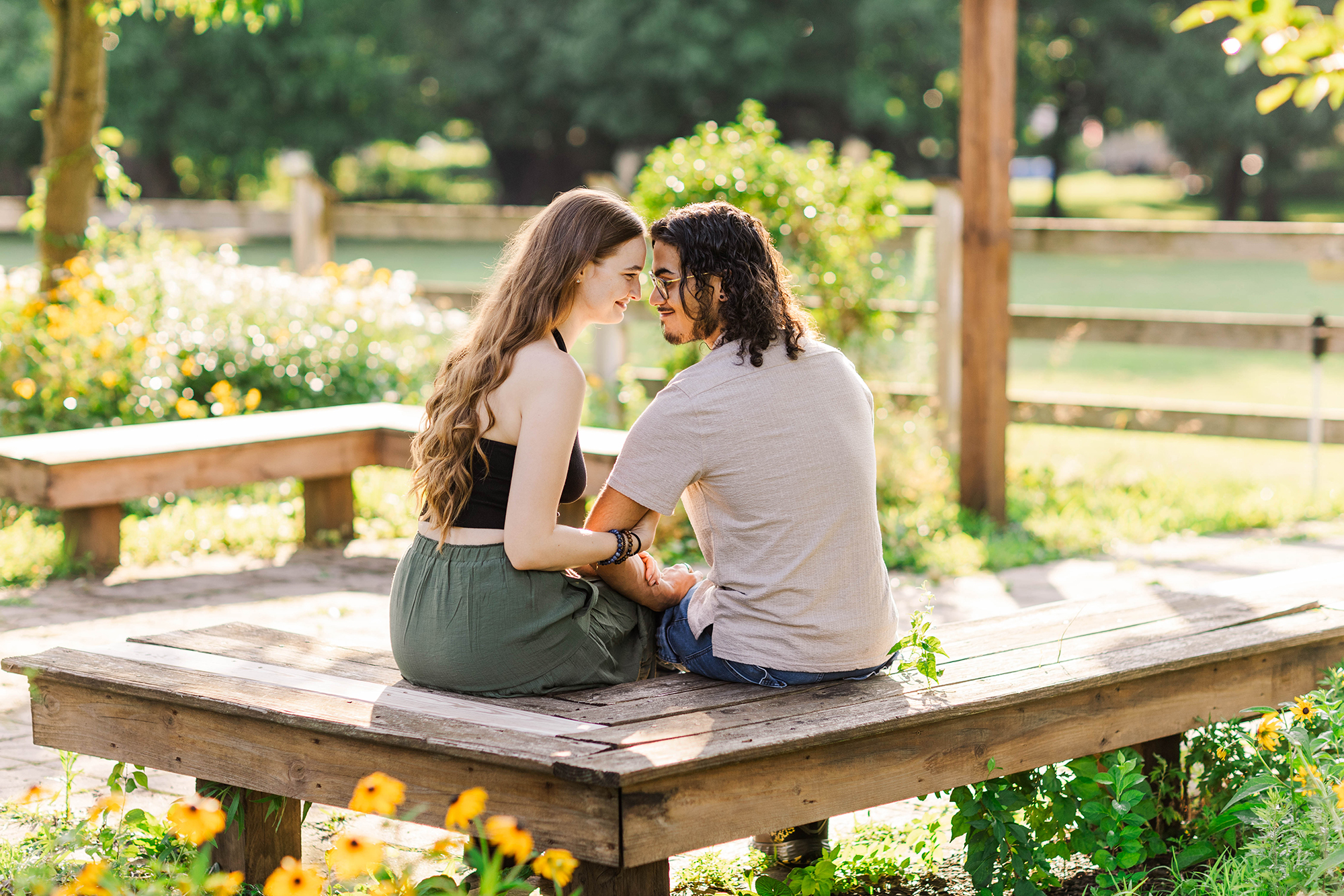 boyfriend and girlfriend sitting on a bench 