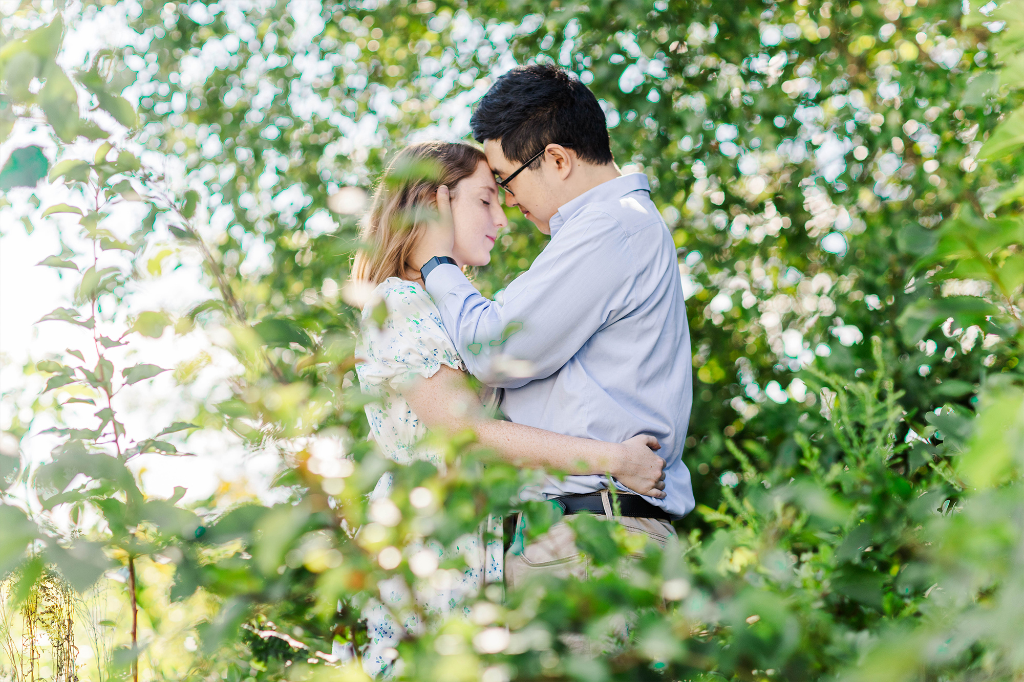 boyfriend and girlfriend embracing in tall grass