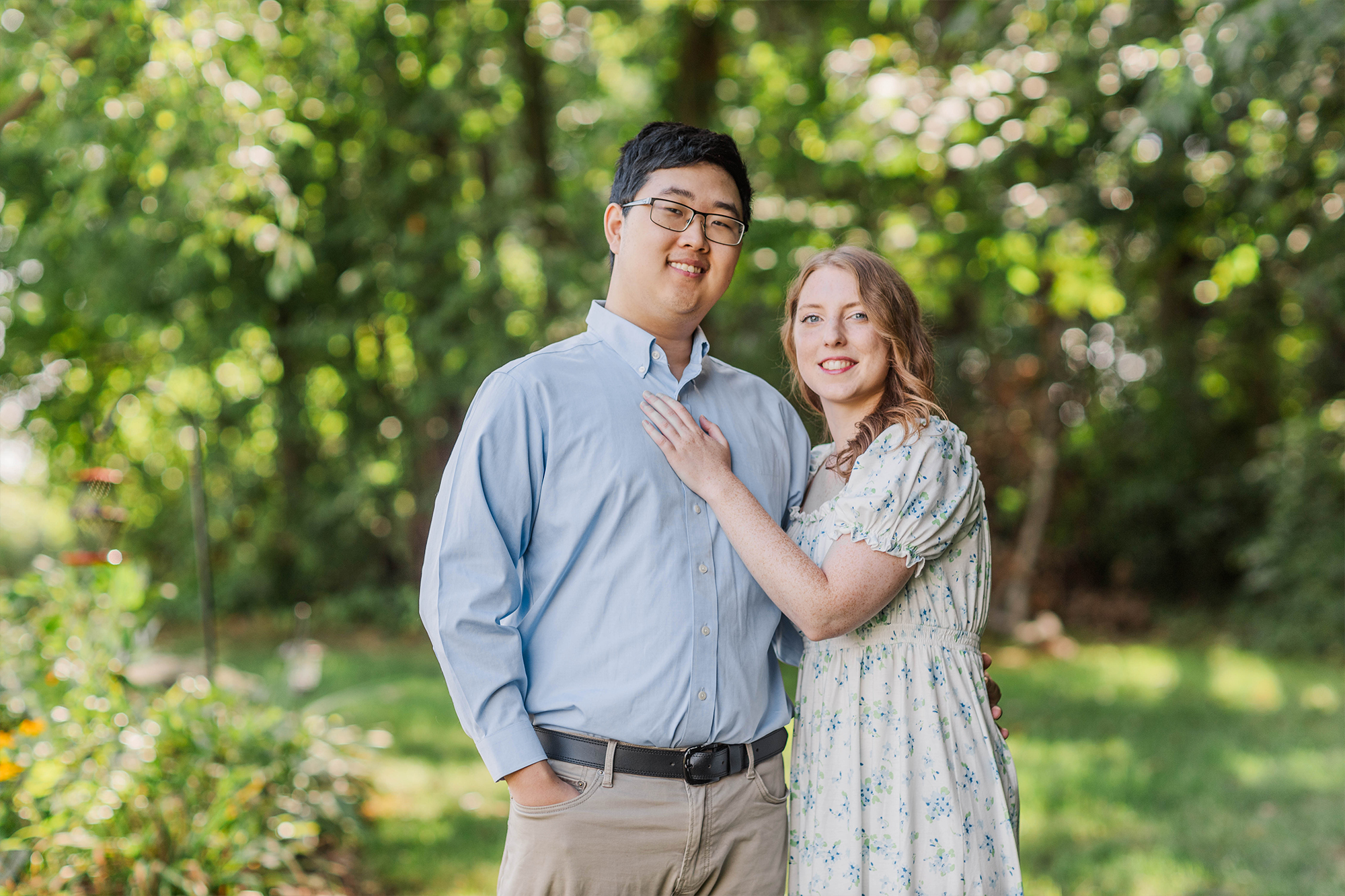 boyfriend and girlfriend posting toward camera outdoors 