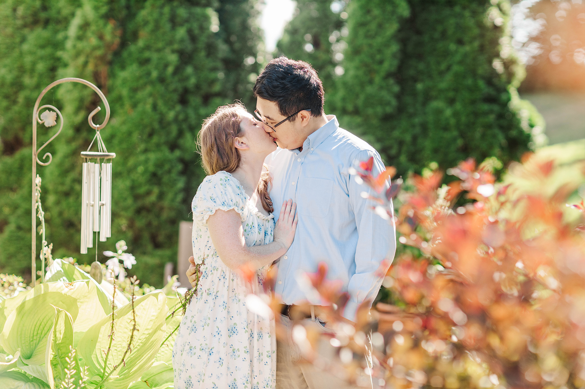 boyfriend and girlfriend sharing a kiss in garden 