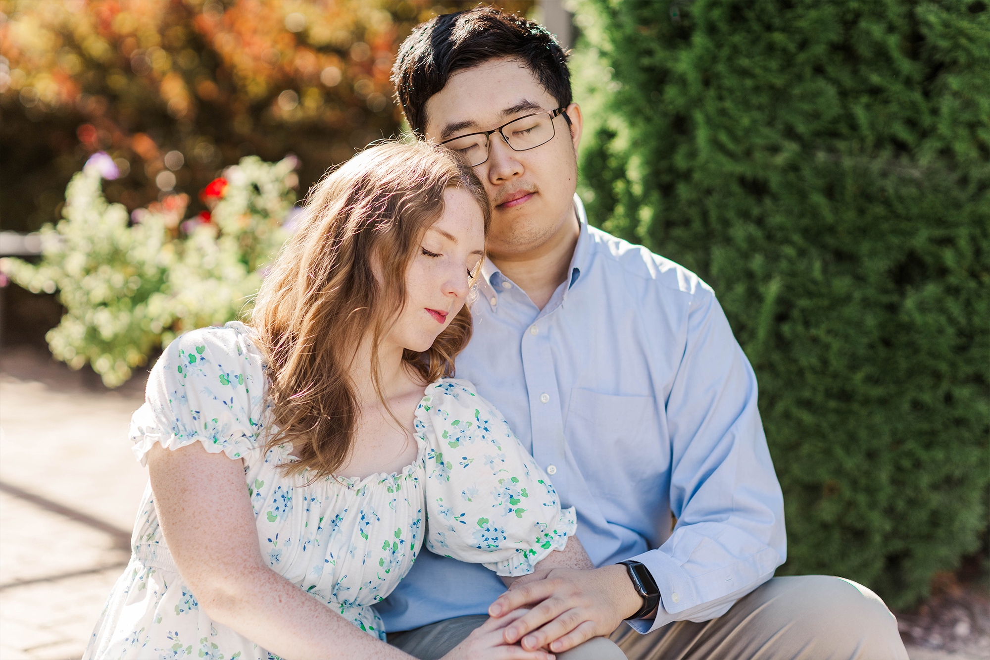 girlfriend laying head on boyfriend while sitting on patio 