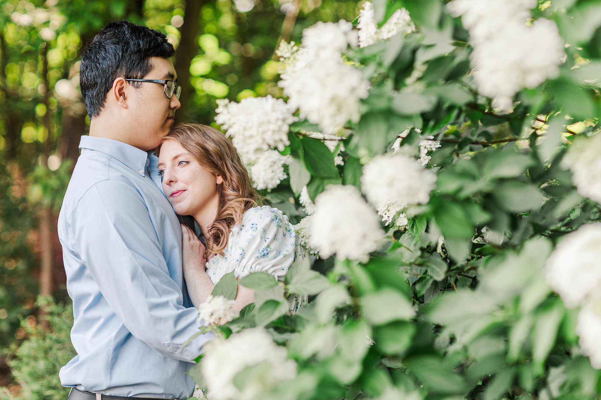 girlfriend hugging boyfriend in tall flowers 