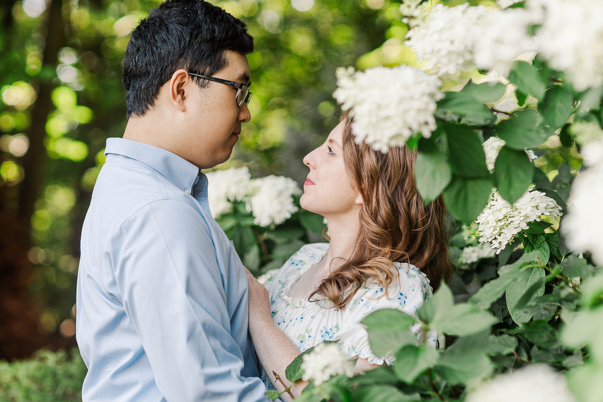 couple sharing a loving stare in tall flowers