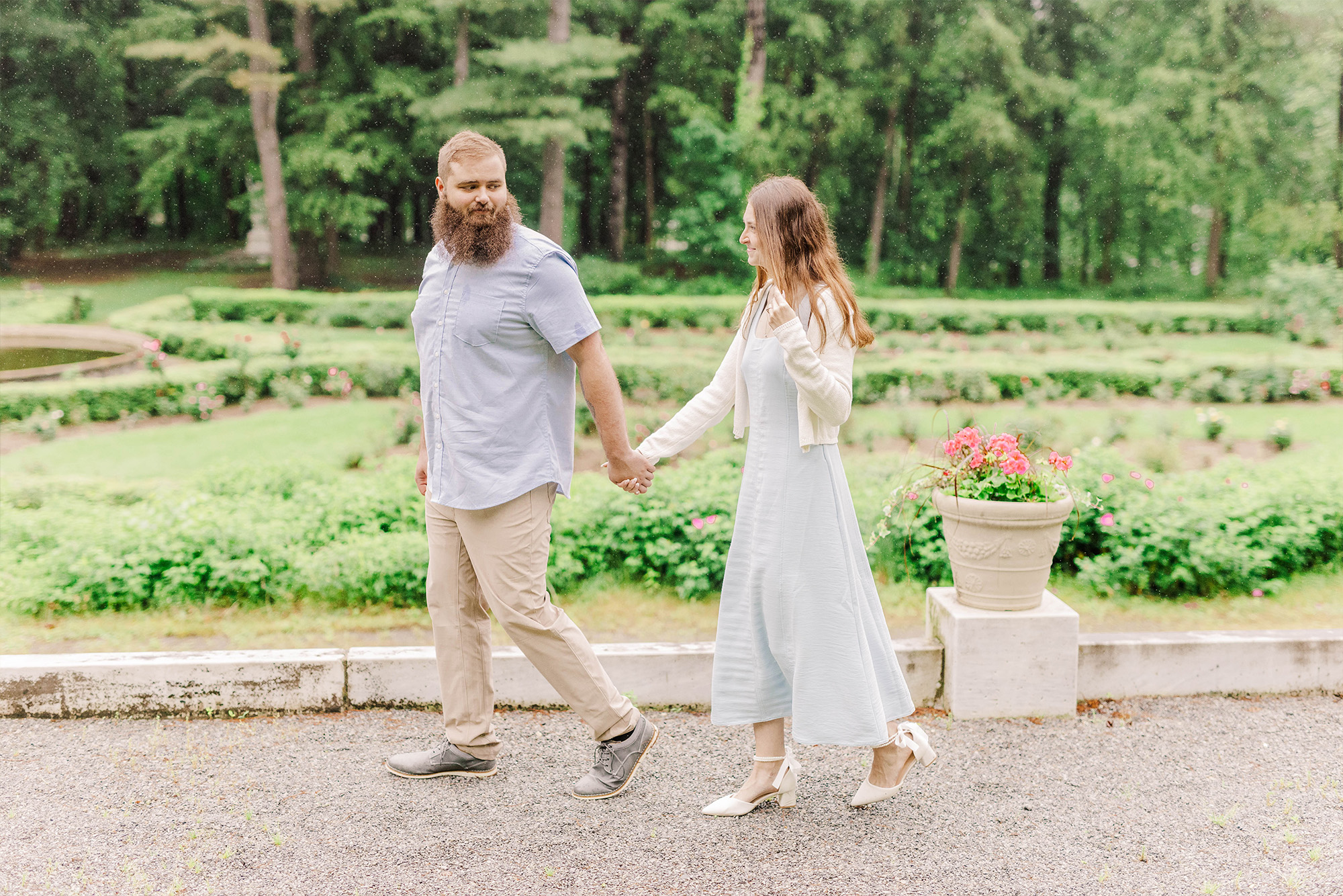 couple walking in the rain in gardens