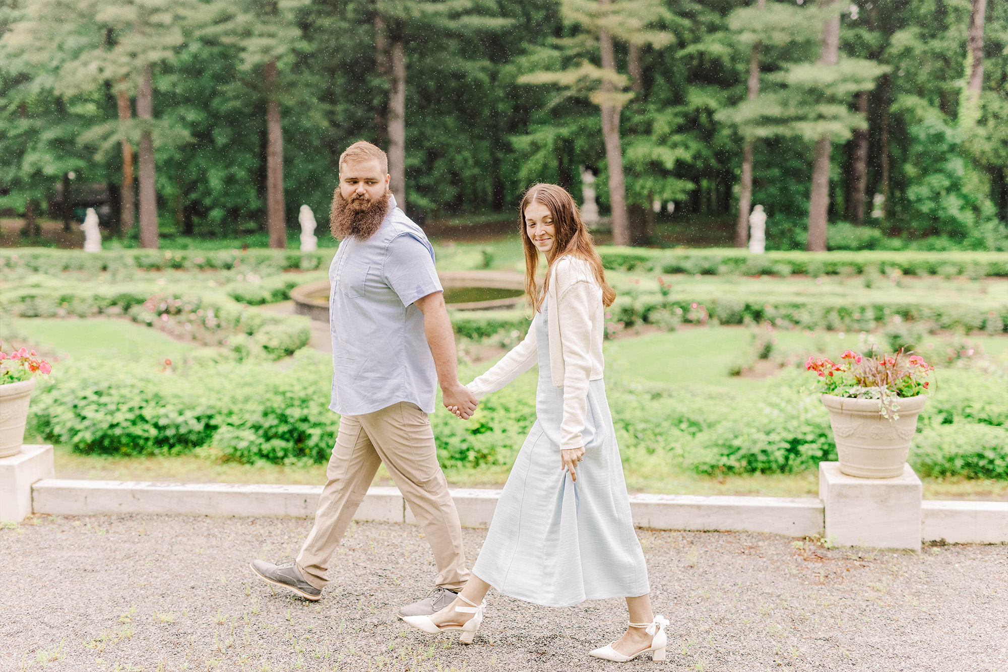 couple walking hand in hand on pathway