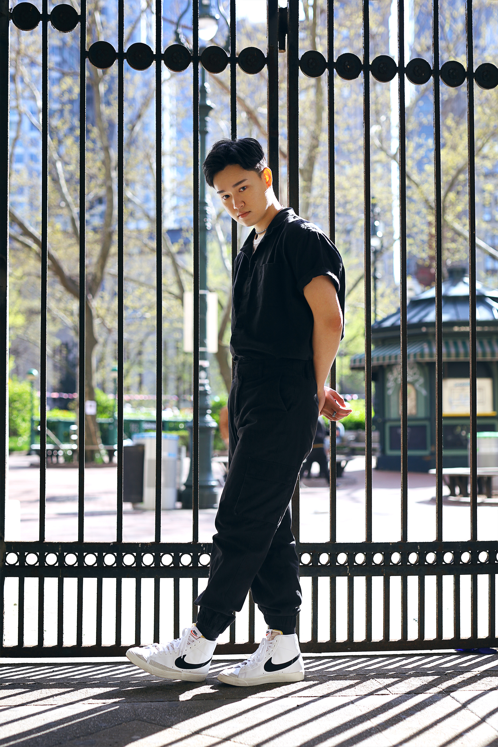 model standing in front of large iron gate