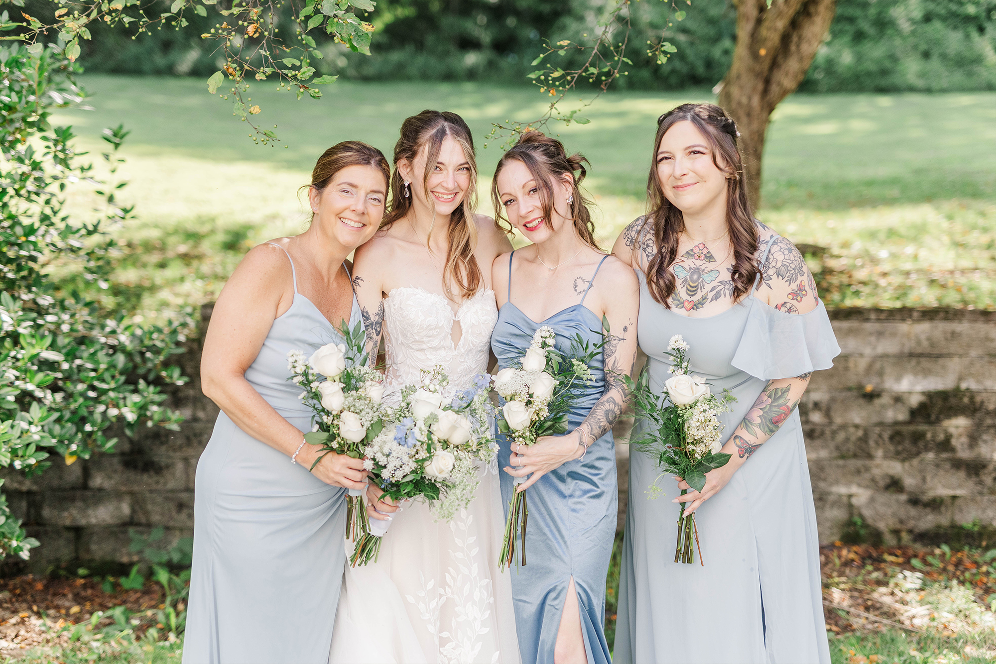 bridesmaids embracing each other with flowers