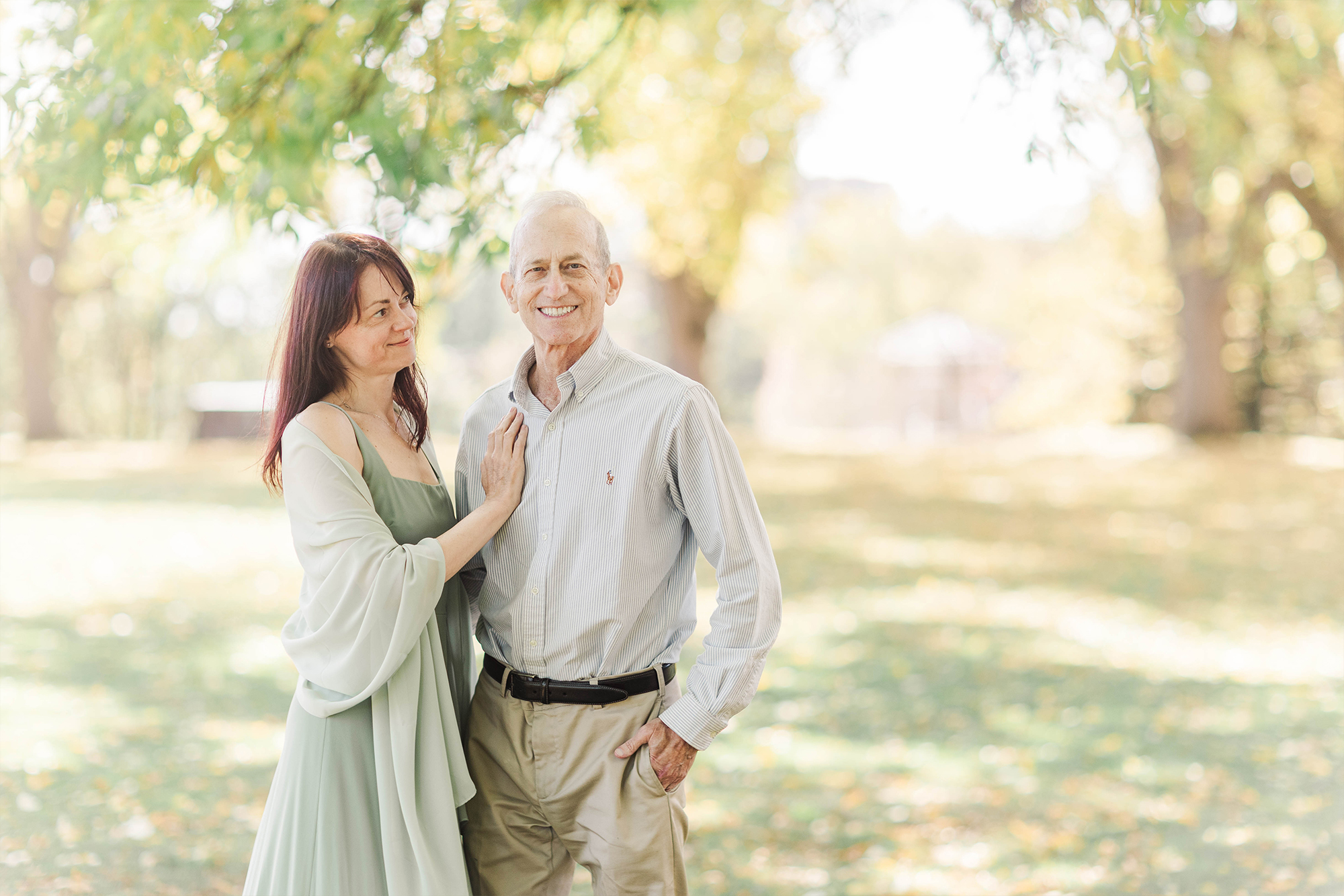 couple posing with greenery and trees