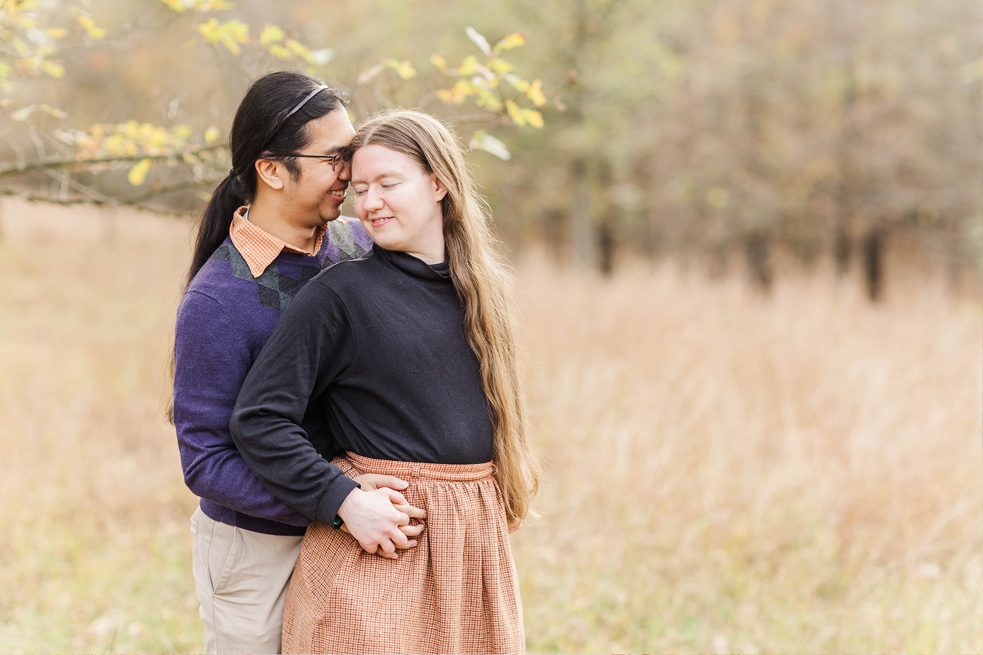 couple embraces each other in park