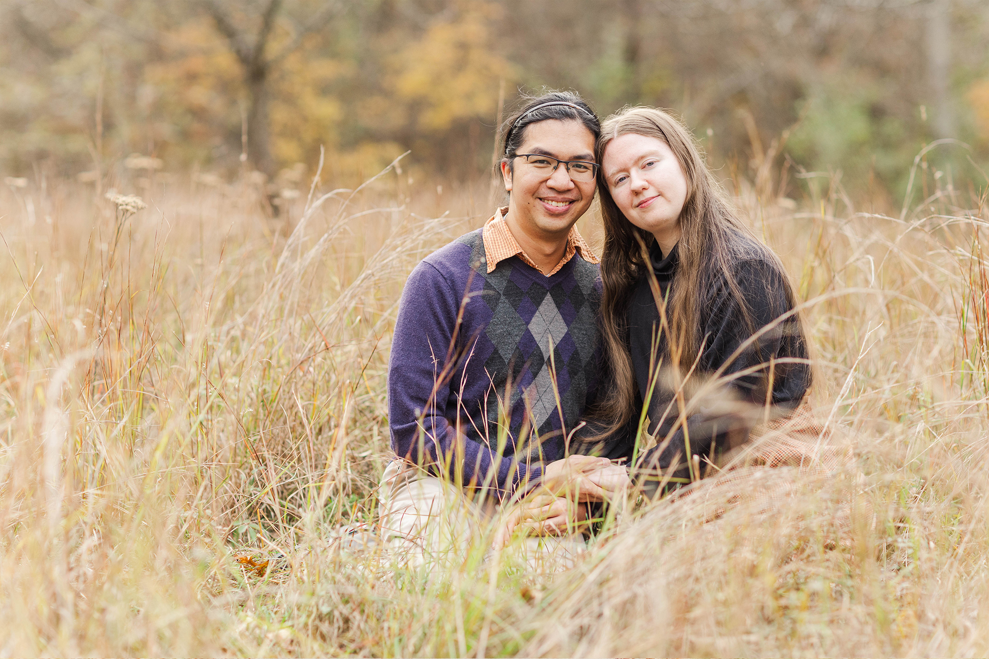 couple sitting with each other in tall grass