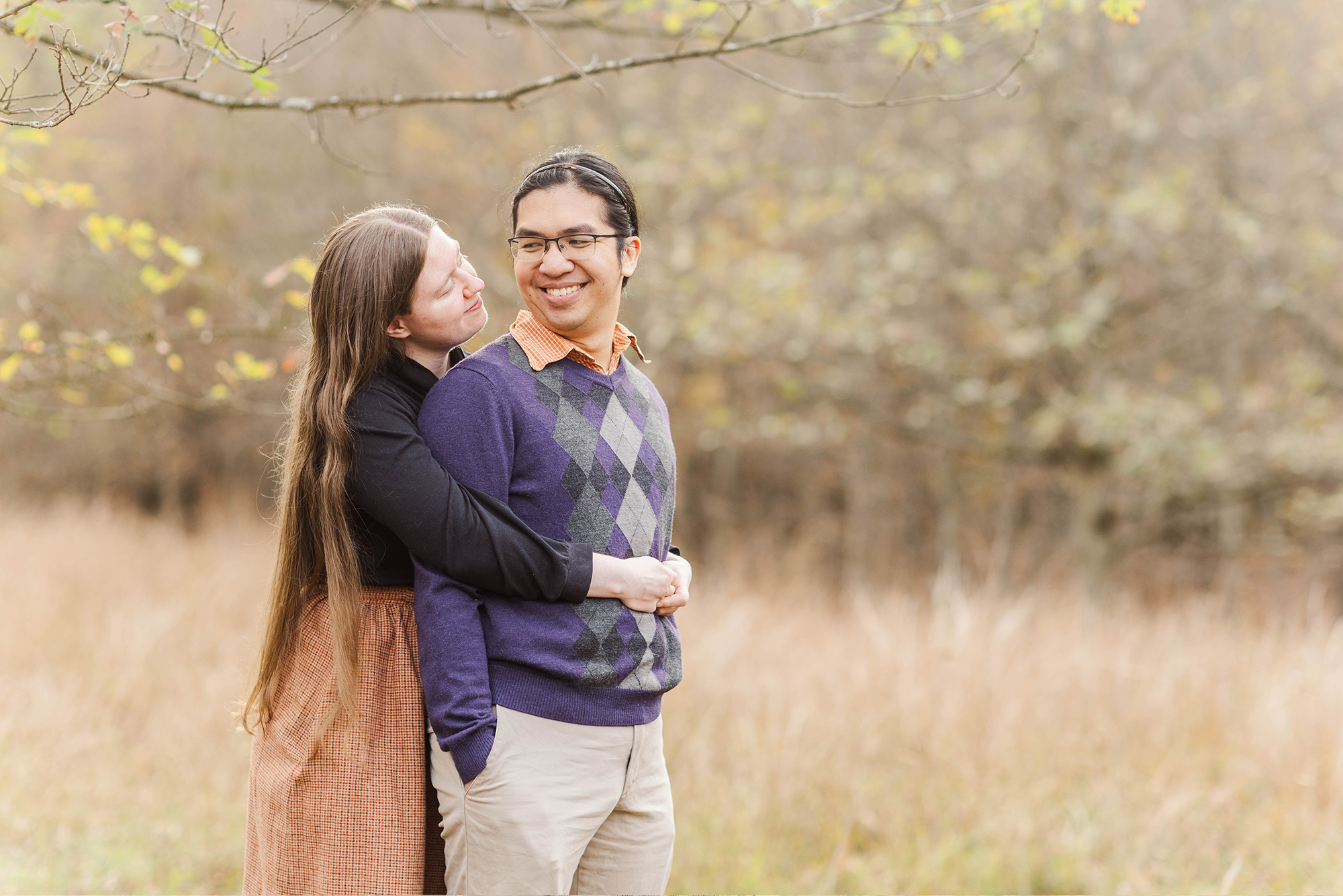 couple sharing a soft stare while posing in park 