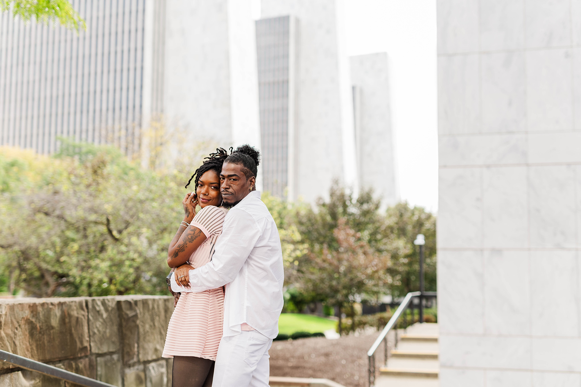 couple embracing each other with city backdrop 
