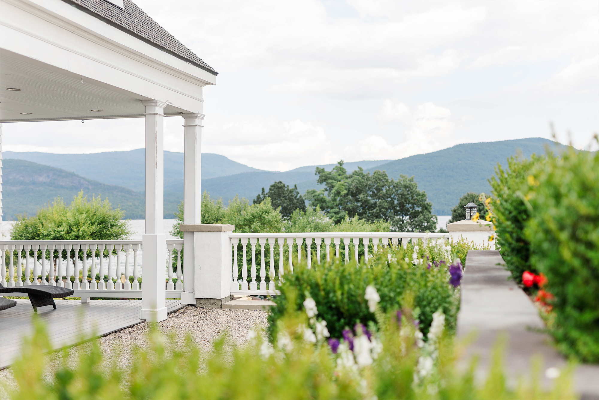 patio and balcony with flowers and greenery with mountains