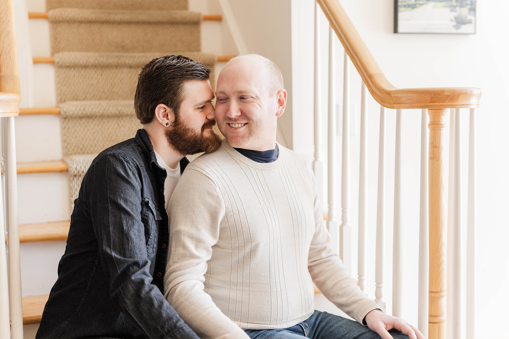 man cuddling with his partner on stairs