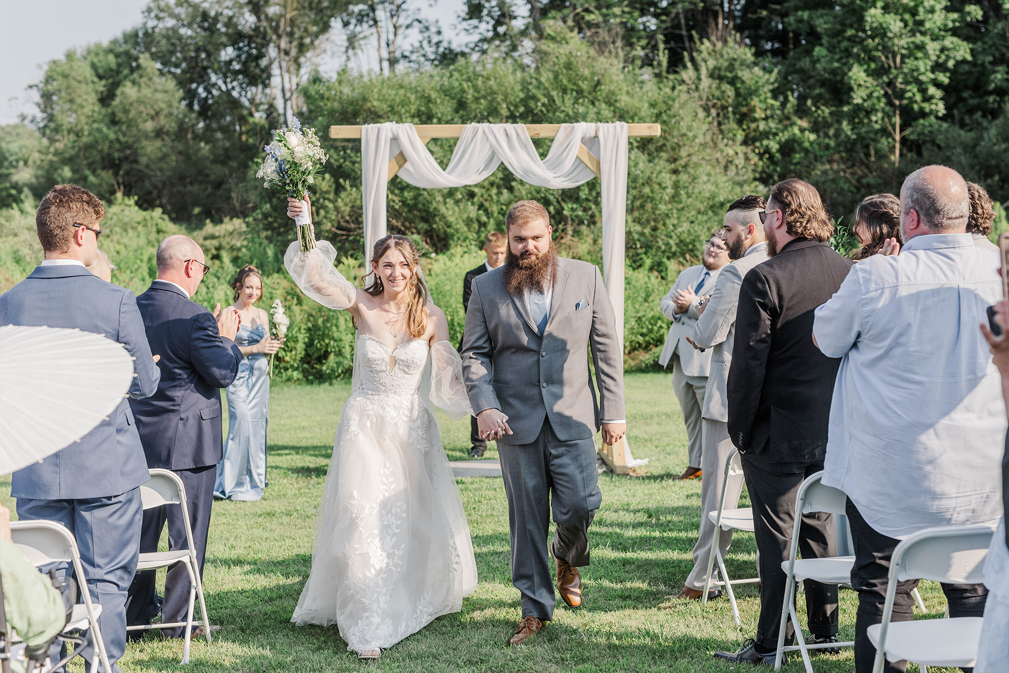 just married couple exiting outdoor ceremony location