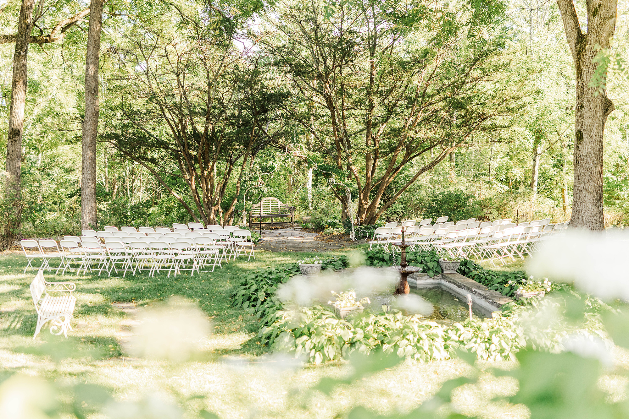 ceremony space with fountain arch and foreground with flowers