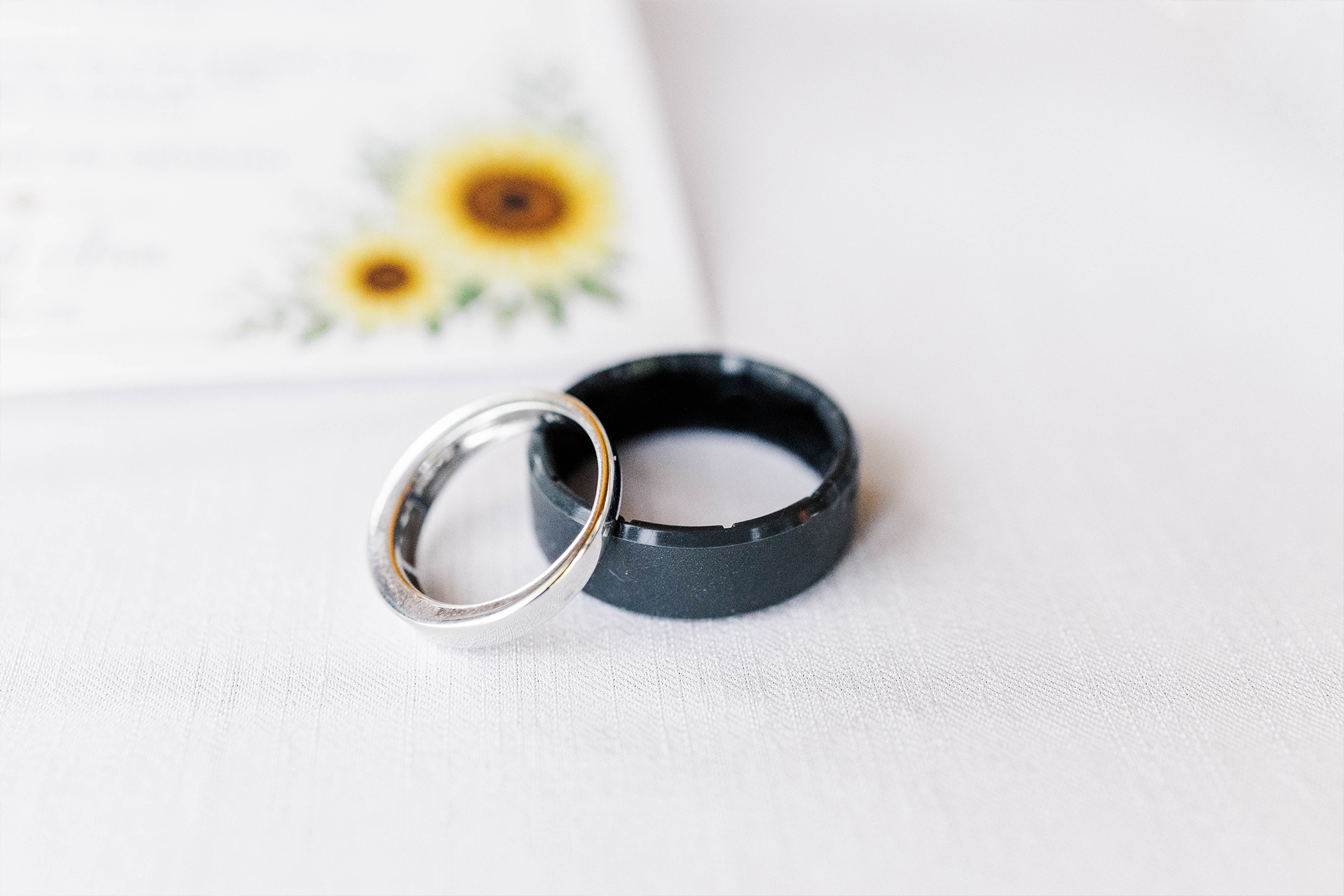 detail shot of wedding bands sitting on reception dining table