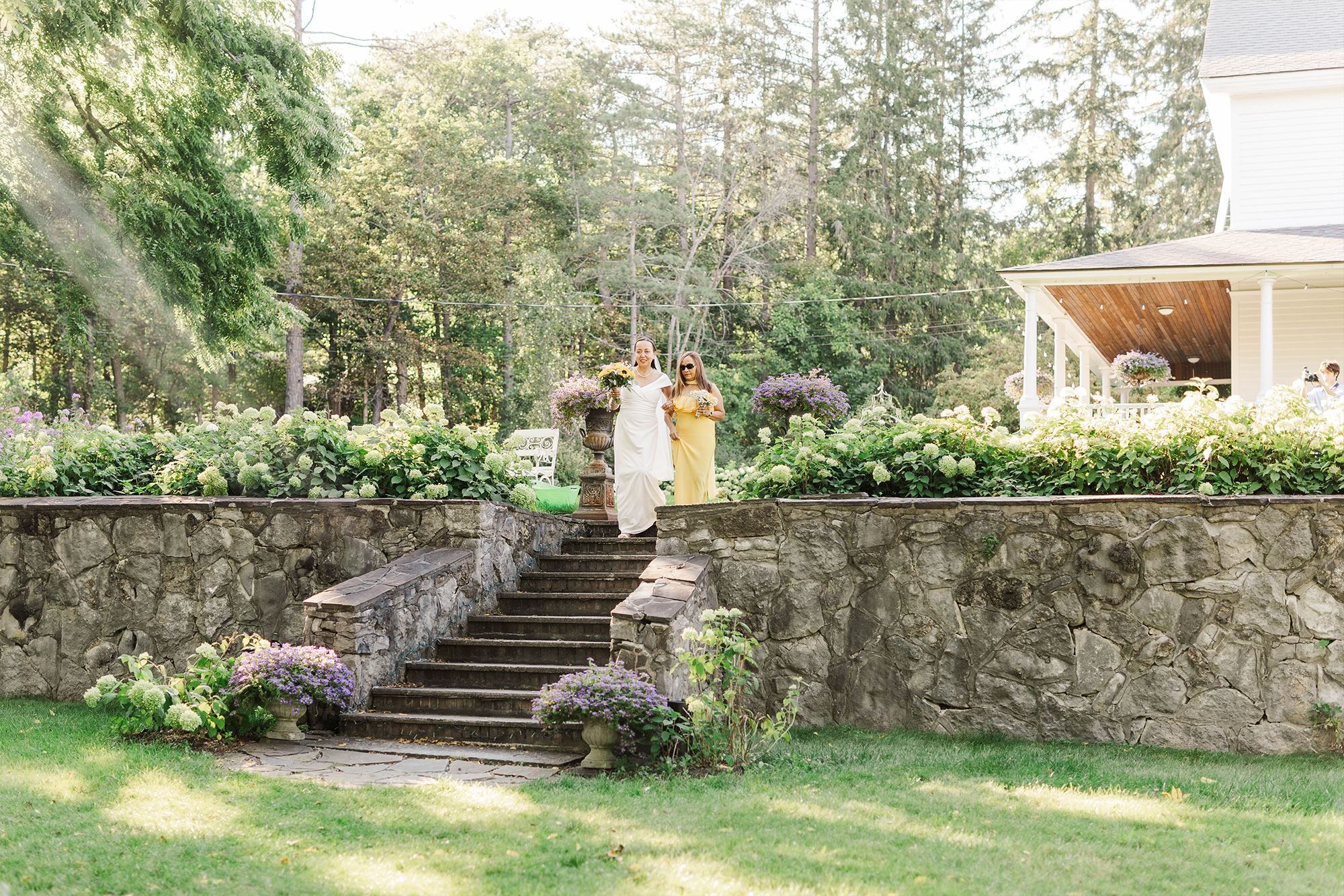 bride and maid of honor walking down stone stairs