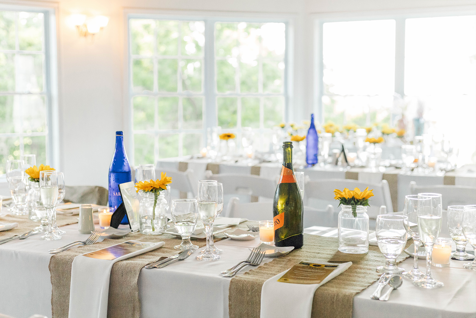 wedding reception table setting with decor and glass bottles
