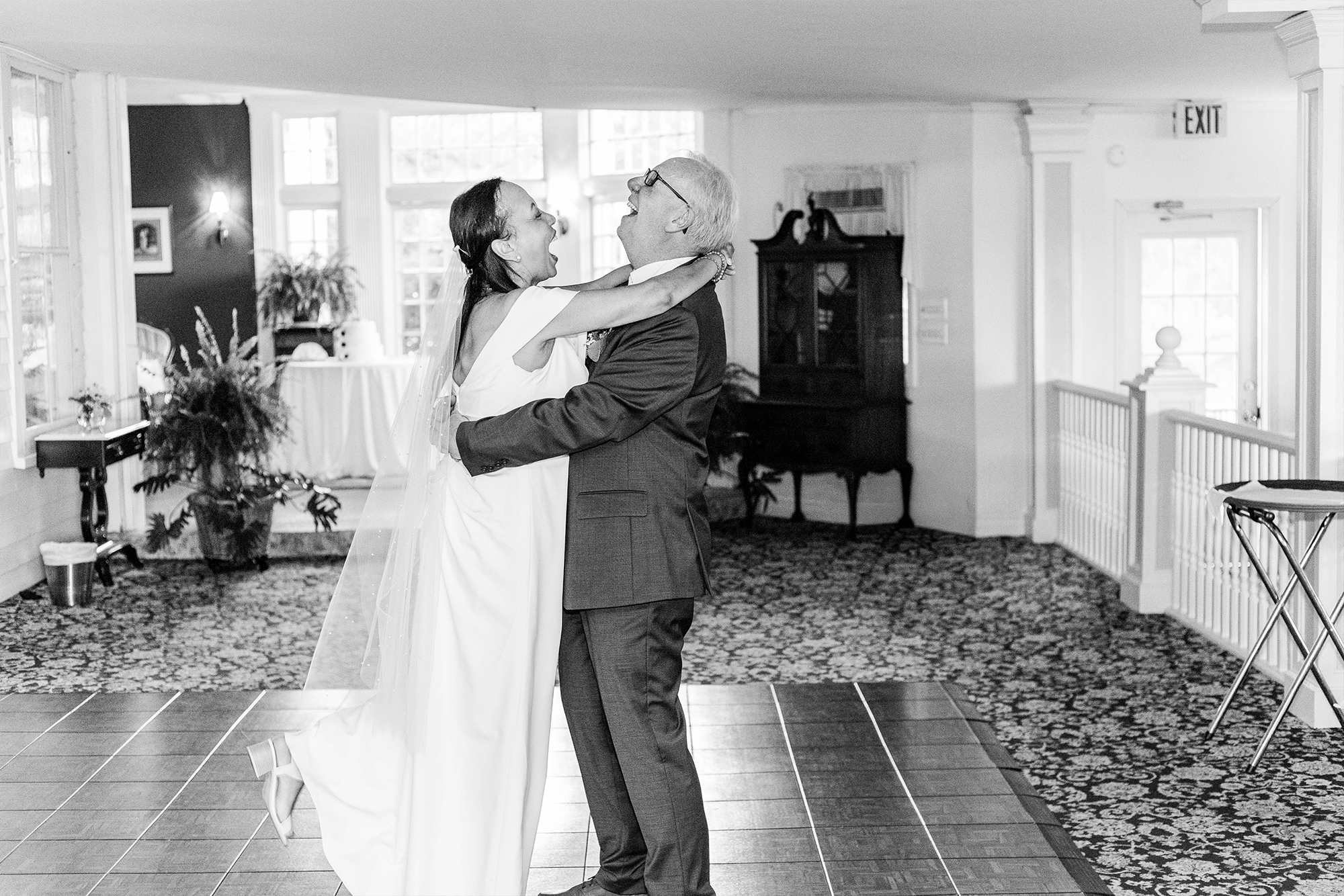bride and groom laughing together on dance floor