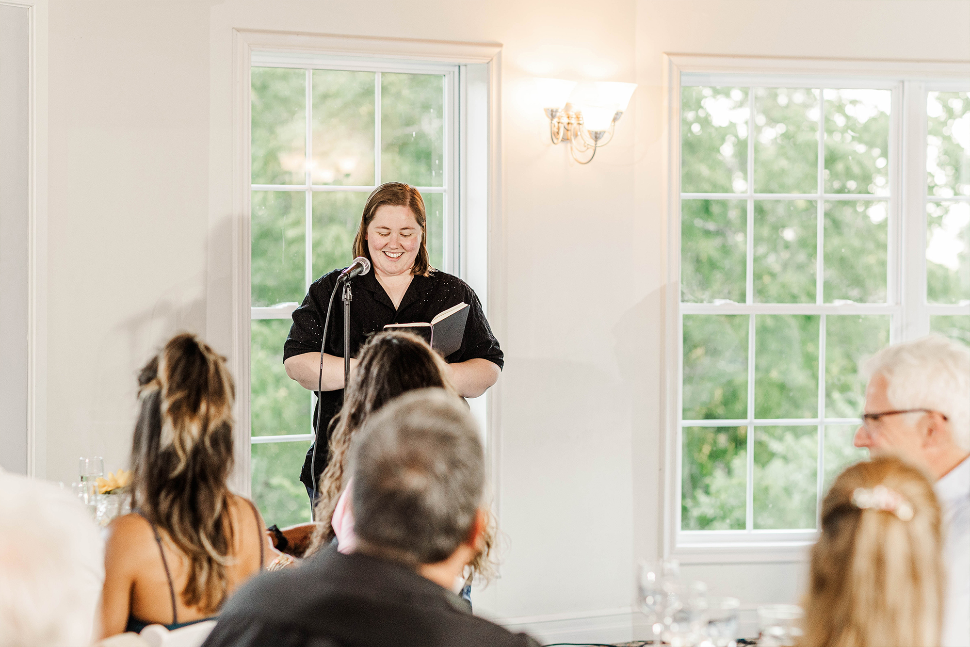 guest making speech at microphone with notebook