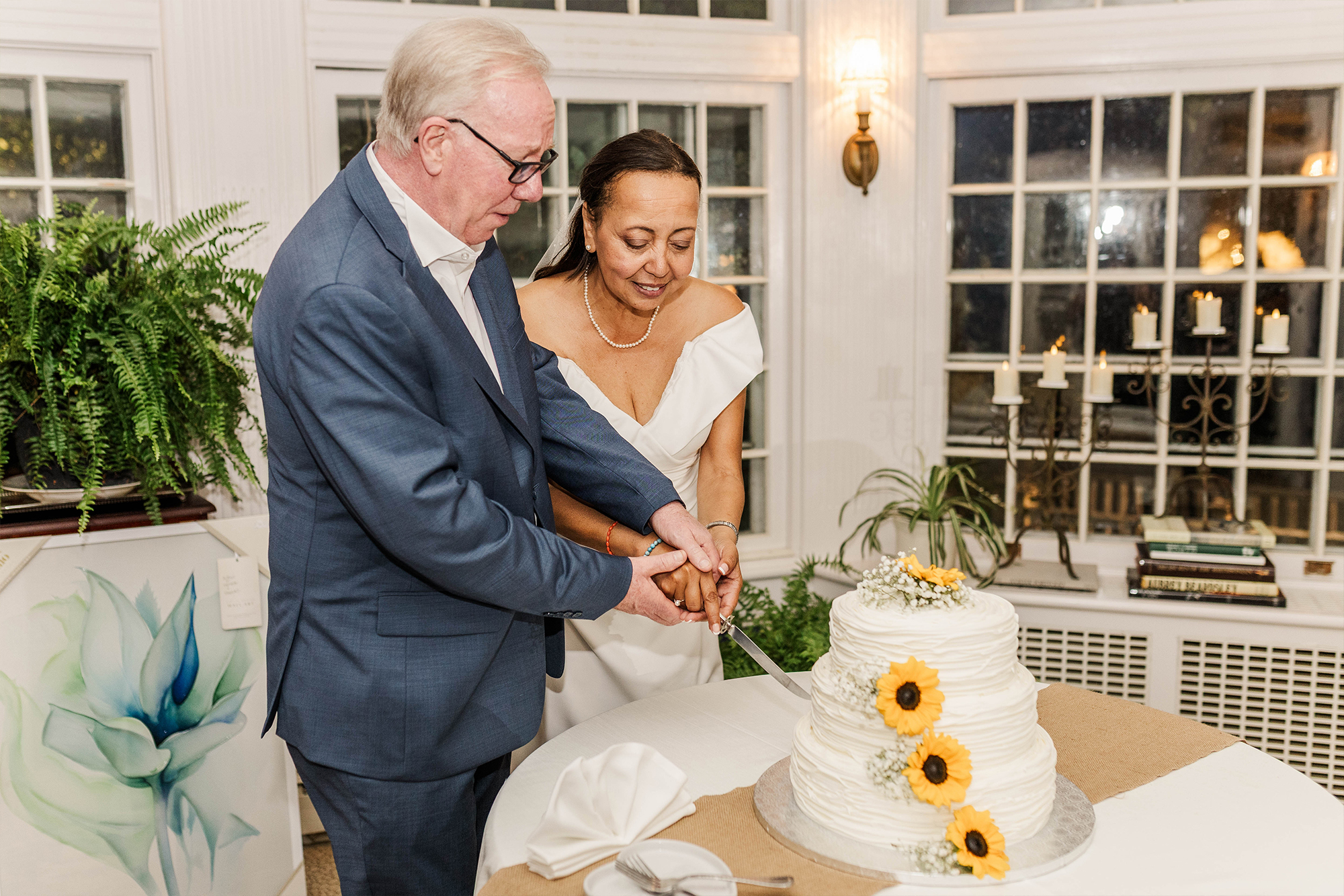 bride and groom cutting cake together