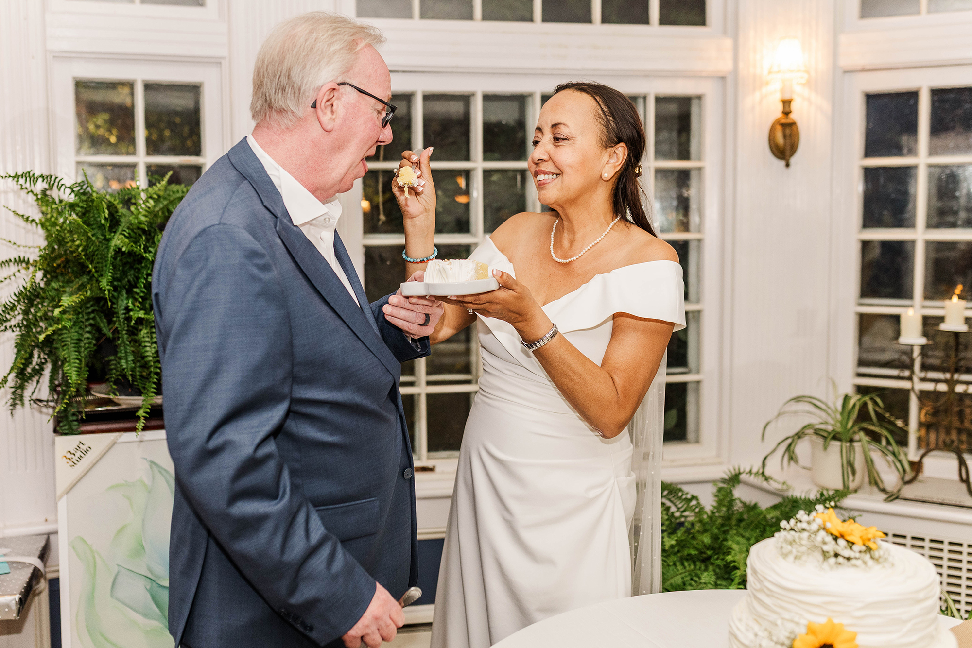 bride feeding groom piece of cake