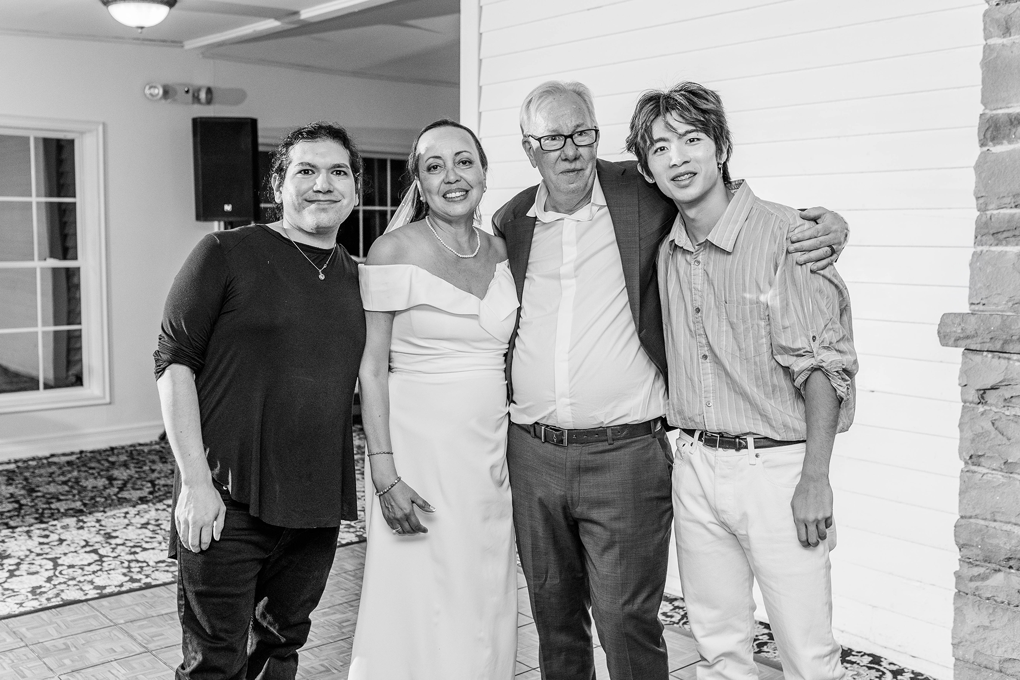 bride and groom with Kosinski Photography photo team during reception